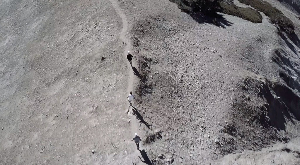 trail running downhill drone