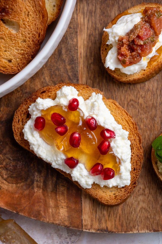 Crostini with ricotta, honey, and pomegranate seeds