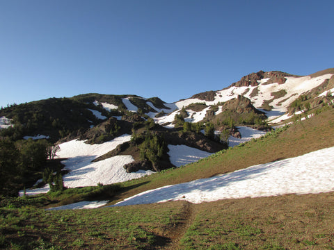 Mountain scape with lake trees and clouds