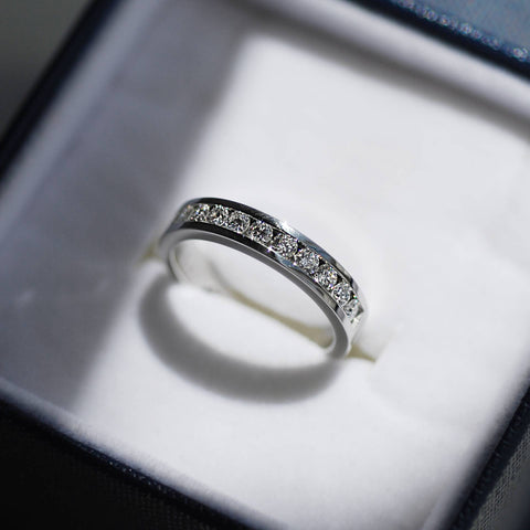 Channel set diamond eternity band in white gold.