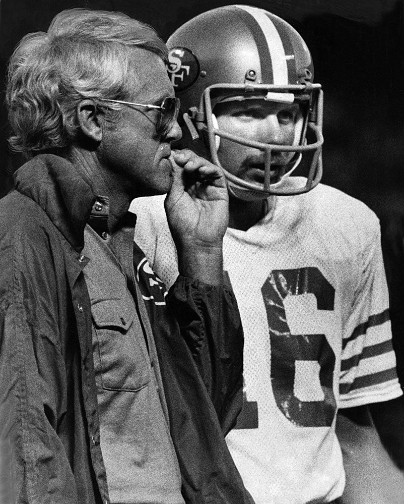 Walsh and Montana confer during a preseason game against the Oakland Raiders on Aug. 12, 1979. JOHN STOREY / THE CHRONICLE