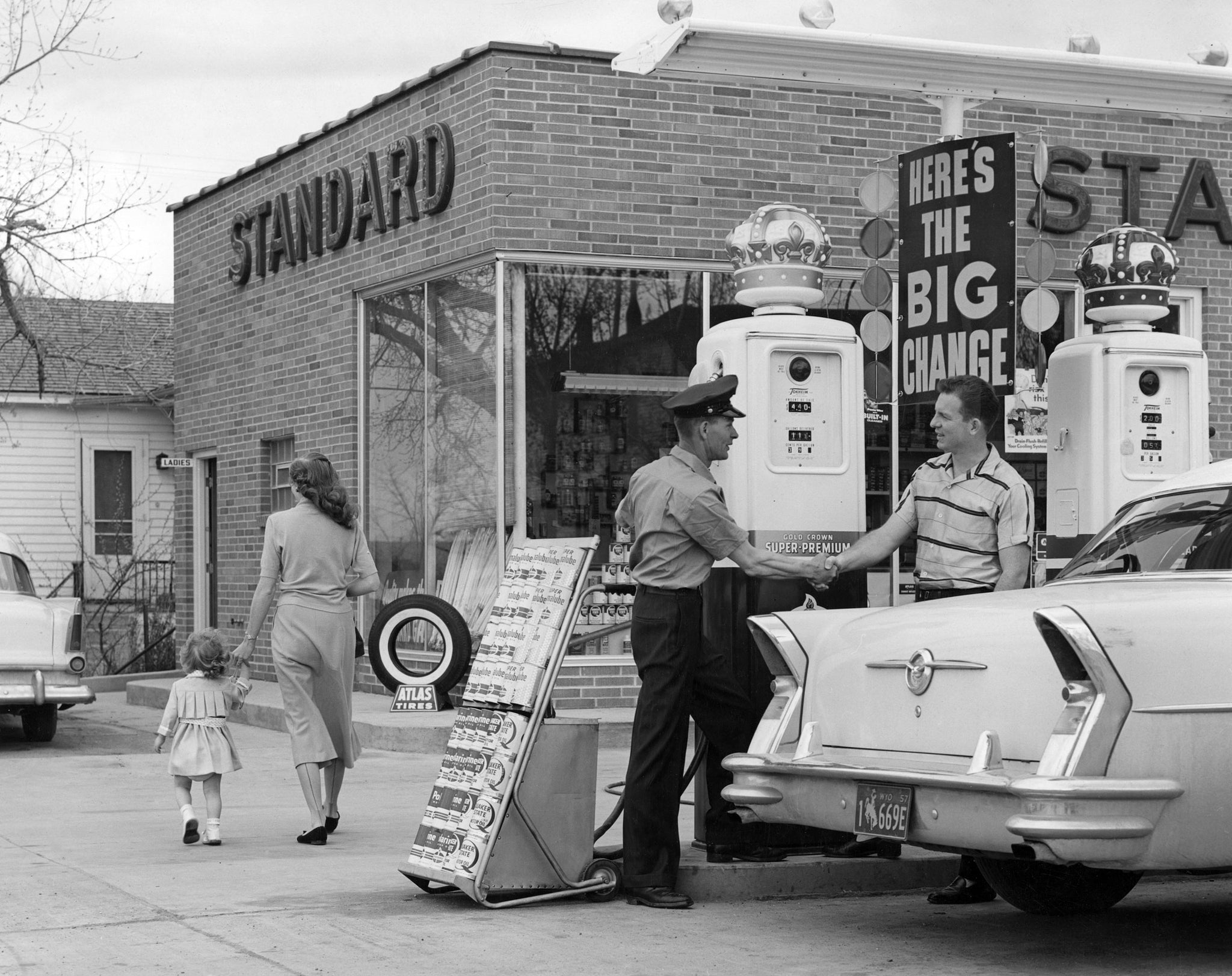 Bill Huffman, center left, shaking the hand of a customer at his Standard Service station at 1008 E. 2nd St., 1957. Standard Oil named it the “station of the year.” -- Courtesy of Carol Knapp