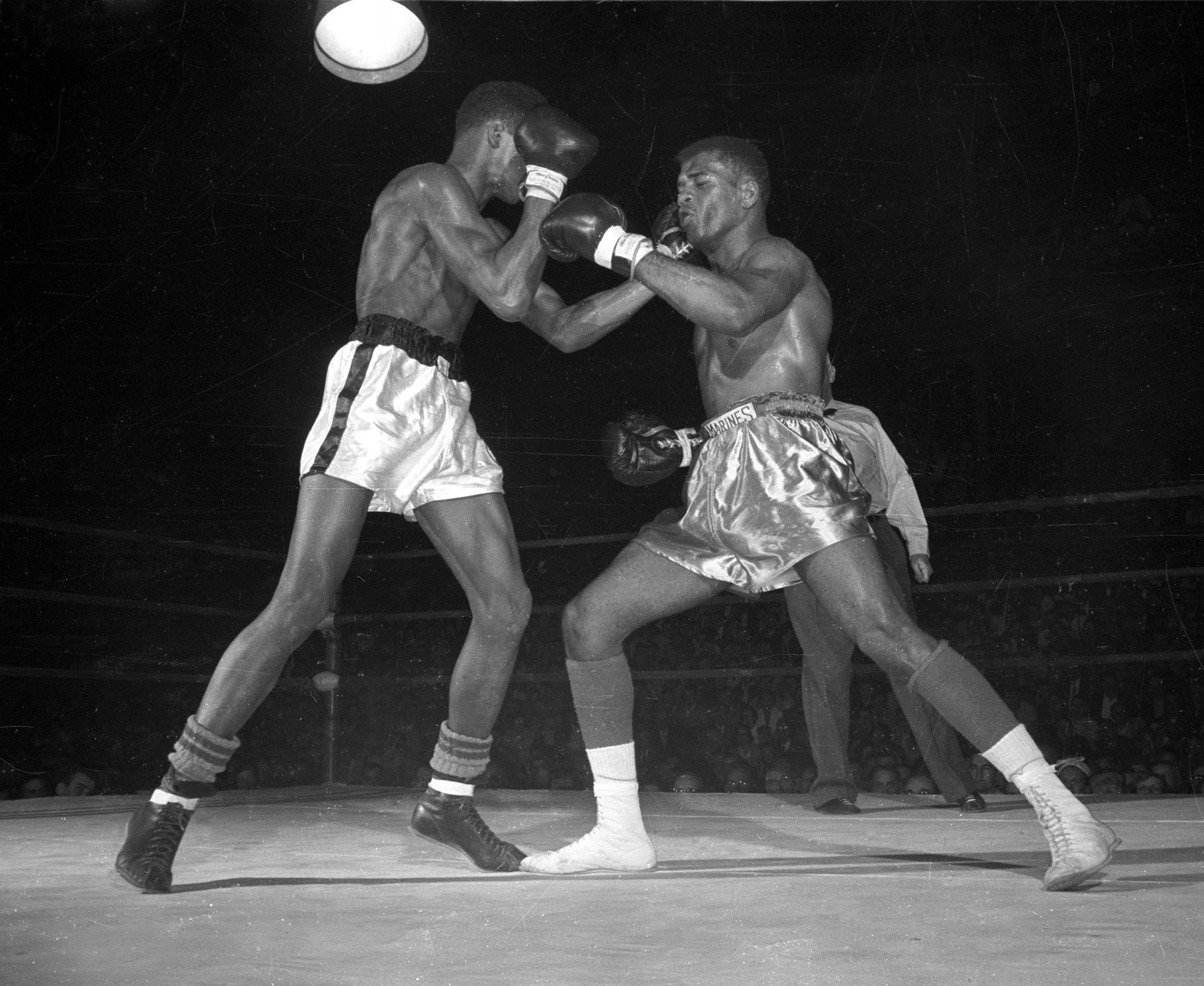 Cassius Marcellus Clay Jr., (white trunks) fighting Amos Johnson in the 178 pound final of the Pan-American Games boxing trials at the University of Wisconsin-Madison Field House. -- Wisconsin Historical Society
