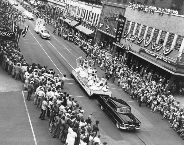 A car pulling the Miss Centennial float for the centennial celebration, 1954. -- Courtesy Grout Museum Archives