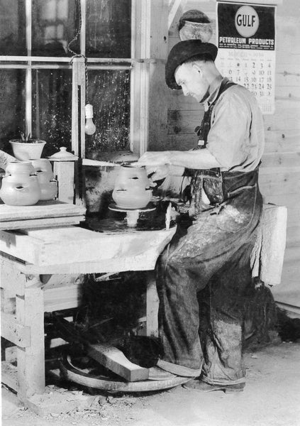 A Seagrove potter turning clay with foot-power, 1939. Kick wheels are turned with foot power. The kick wheel was revised into a treadle wheel to make the speed of the wheel easier to control and to reduce wear and tear on potters’ hips and legs. -- Courtesy The Courier-Tribune