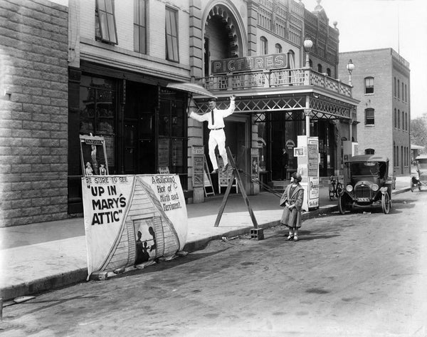 A man walking a tight rope in front of the Ludcke Theatre in St. Peter, circa 1920. -- Courtesy Nicollet County Historical Society