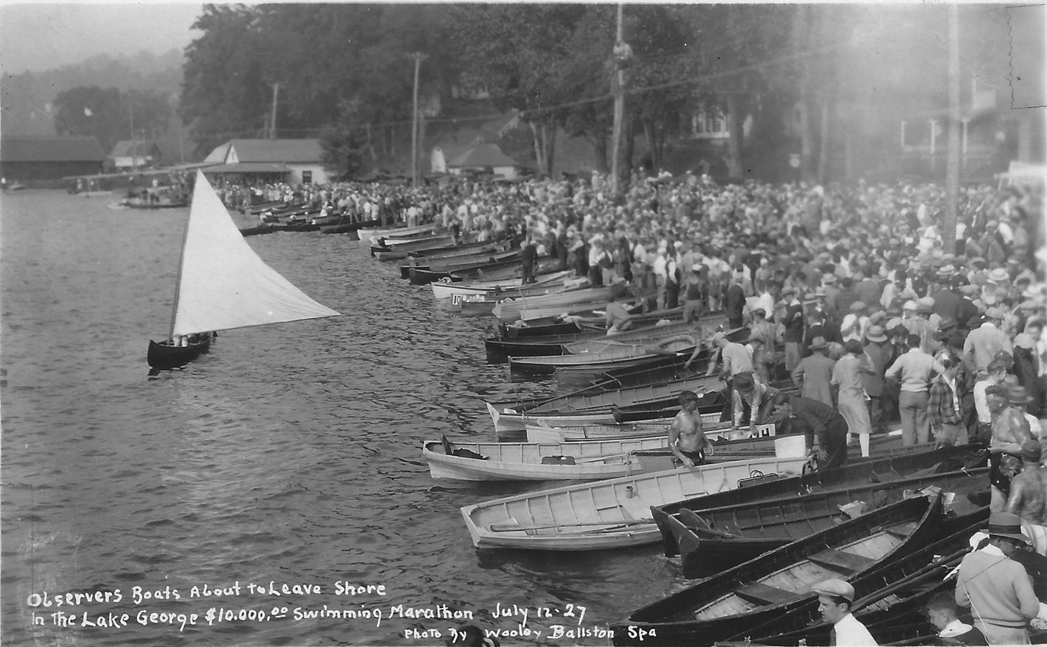 The Lake George Swimming Marathon, held in July of 1927, drew 146 competitors from six countries and nearly every state in the U.S. Heavyweight boxing champion Jack Dempsey traveled to Hague to fire the starting pistol. Prizes included $10,000 in cash, valuable real estate as well as cups and medals. The 24-mile course set up for the marathon ran from the Trout House in Hague to the Fort William Henry Hotel. Eighteen and one half hours after the start in Hague, New York City swimmer, Edward Keeting, crossed the finish line in Lake George Village. Former Hague Historian Clifton West, who was 18 at the time of the marathon, remembered that so many people had crowded onto the platform leading out to the pier, that it gave way when Dempsey stepped onto it, sending him and about a dozen of his fans into the ankle-deep water. Dempsey was unscathed, though his fashionable shoes were soaked through. Rule #12 stated: “Any class of bathing suit… can be used. Suits can be abolished entirely if swimmer chooses to use a covering only of grease.” Warren County Sanitary Inspector Harry Smith announced before the race that the grease could jeopardize the quality of Lake George’s water. The swimmers, however, rallied at the Lake George Courthouse and were able to convince him that the grease was a natural substance (wool fat or lanolin) and would not harm the lake. -- Hague Historical Society