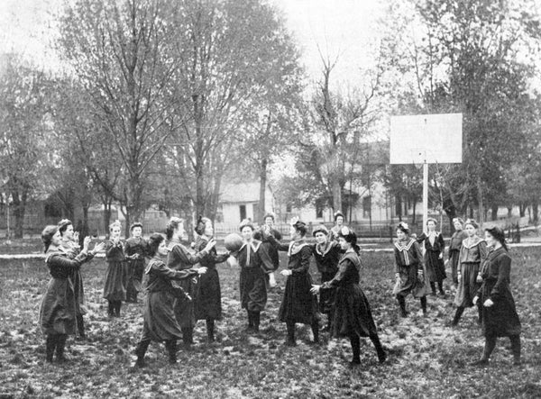 Girls playing basketball on the Southern Illinois Normal University campus, circa 1904. -- Southern Illinois University Archives, Southern Illinois University Carbondale Collection, Box 1-Folder 17