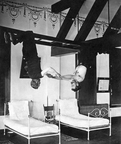 Firemen hanging upside down from a ladder in the station in Mankato, circa 1910. -- Courtesy Blue Earth County Historical Society