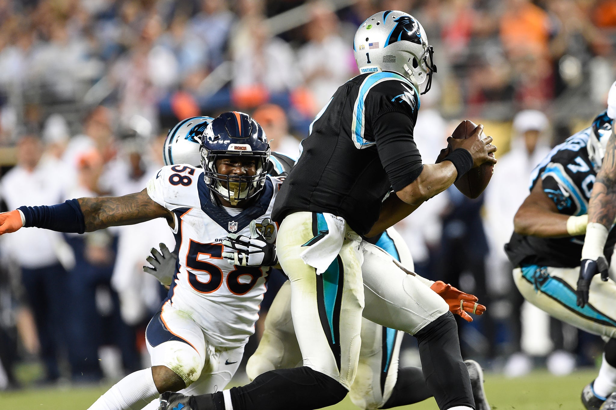 Von Miller (58) of the Denver Broncos sets his sights on Cam Newton (1) of the Carolina Panthers in the fourth quarter of Super Bowl 50.  -- Photo by Joe Amon/The Denver Post