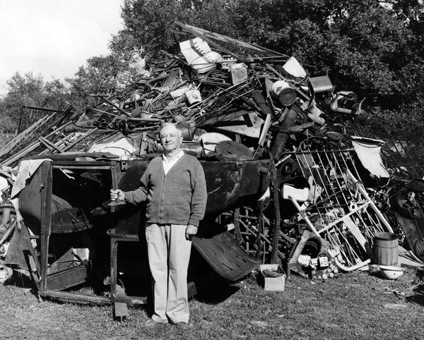 Chesterton Town Marshal Joe LaRoche in front of scrap metal collected during a drive for World War II, 1942. -- WESTCHESTER TOWNSHIP HISTORY MUSEUM
