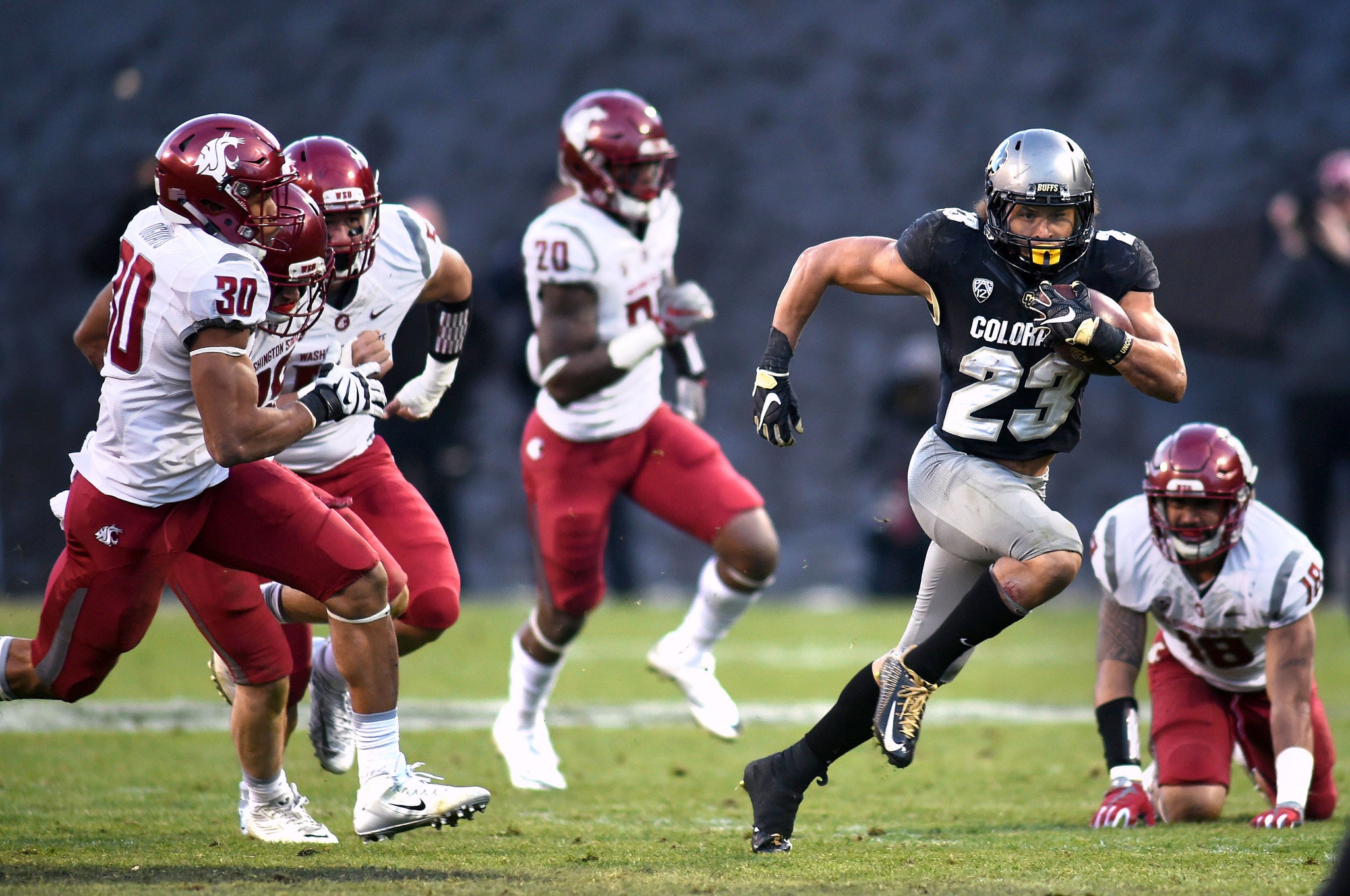 Colorado’s Phillip Lindsay tries to escape the Washington State defense. -- Cliff Grassmick