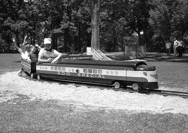 The "Zoo Special" train across from the Weed Park Zoo, 1959. At one time the park also had a small roller coaster. -- Muscatine Journal