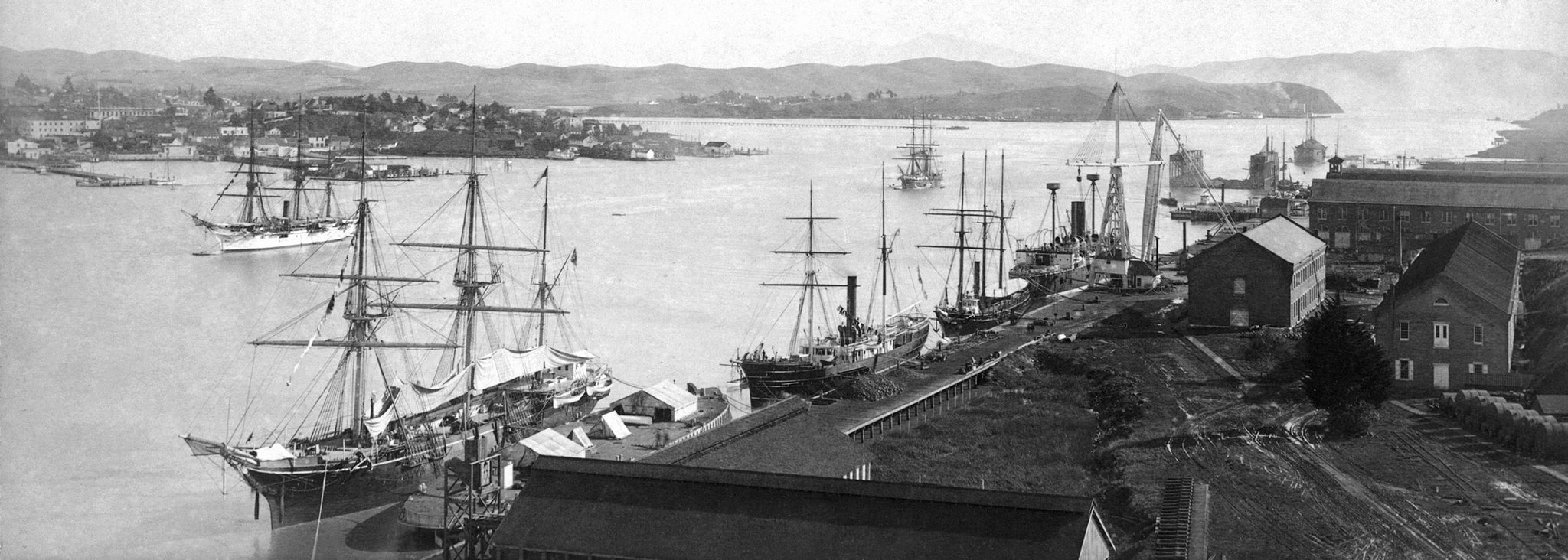 Mare Island waterfront looking south, 1890s. The USS Independence is pictured. Vallejo is visible across the Mare Island Straits. -- Courtesy Vallejo Naval and Historical Museum