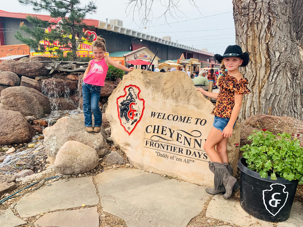 Taylor and Jordan Williams, from Georgia, with the Cheyenne Frontier Days sign. MEGAN WILLIAMS