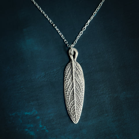 Silver Sage Leaf Necklace on blue background