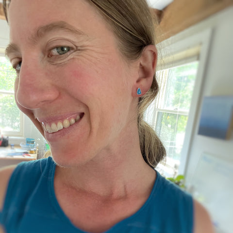 Vermont jeweler Allison Korn smiles wearing her silver Dawn Sky Stud earrings