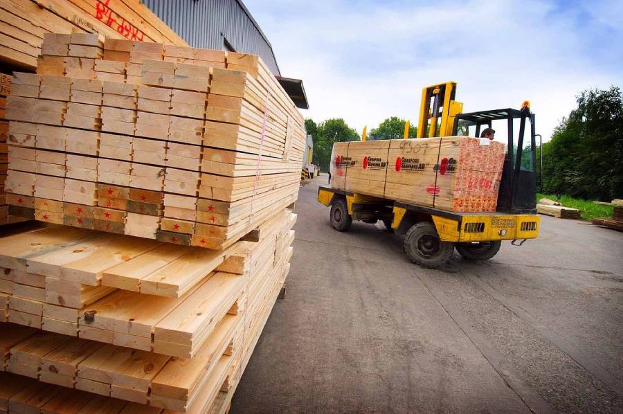 Plywood being loaded and moved