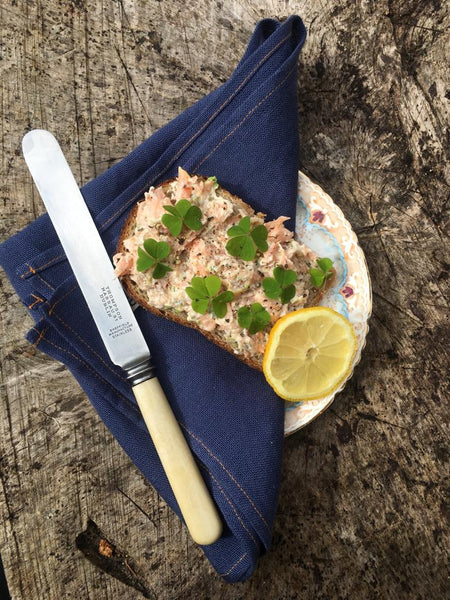 Fresh salmon open sandwich with wood sorrel, dill mayo and black pepper