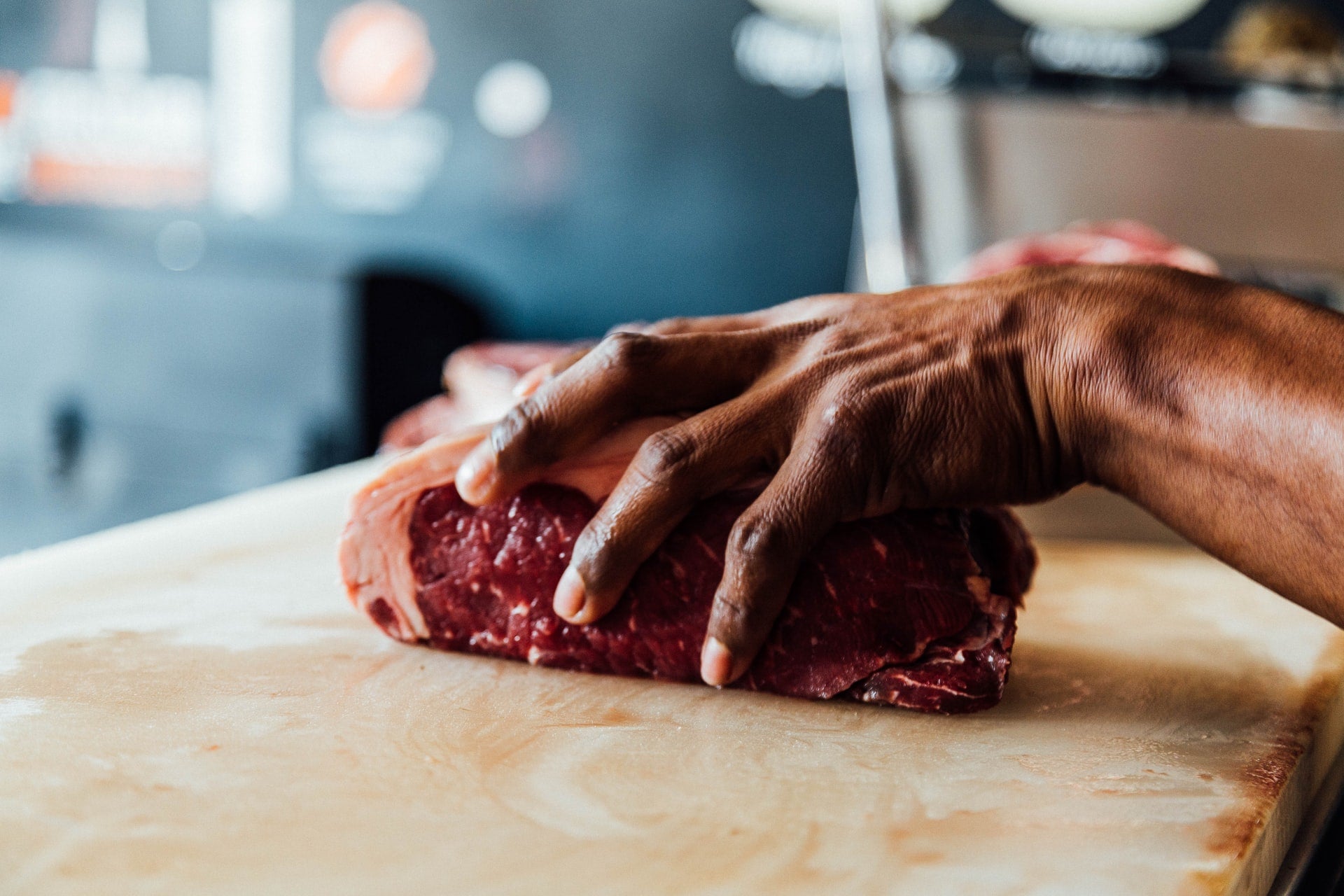 Butcher Cutting Beef at a Butcher Shop