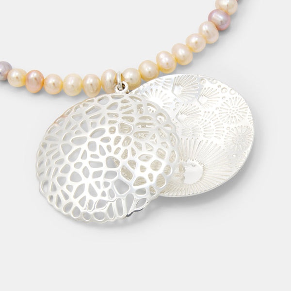 Statement jewellery, including coral reef pendant necklace with peach pearls.