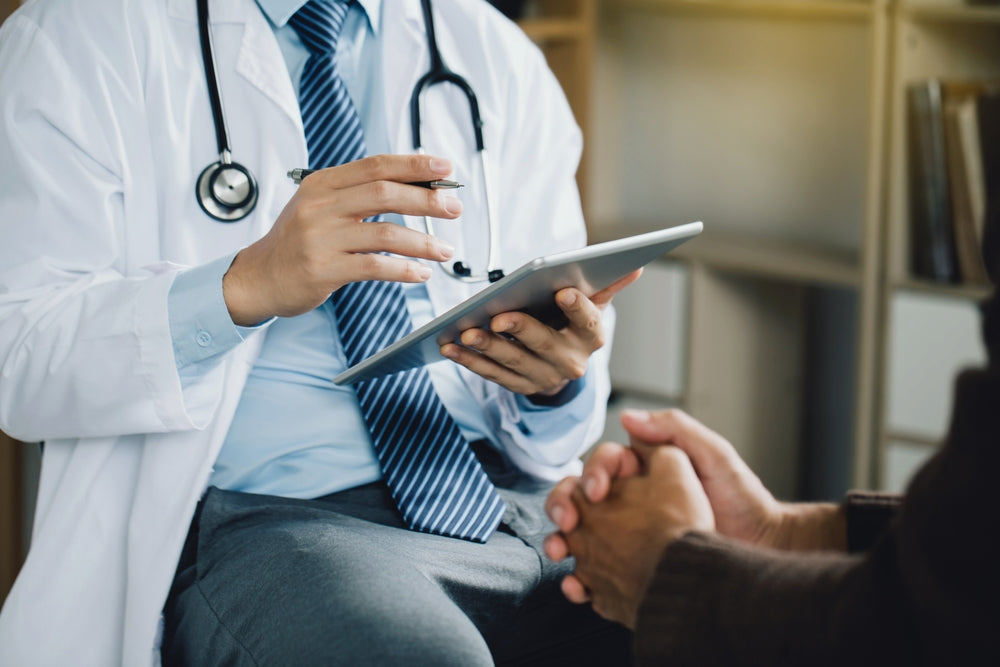 A psychiatrist in a white coat talks with a patient.