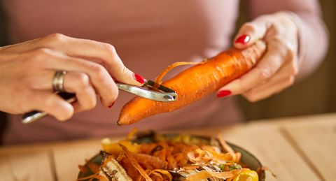 person peeling carrot