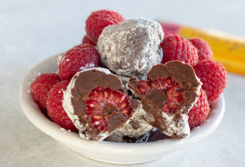 Raspberry truffles mixed with fresh raspberries