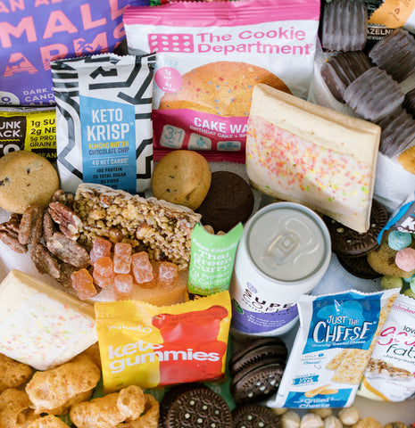 pile of snacks from KetoKrate, including gummy bears, toaster pastry, granola bar, and cereal