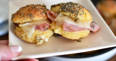 Two ham and cheese sliders on a plate