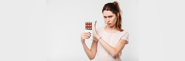 woman resisting chocolate