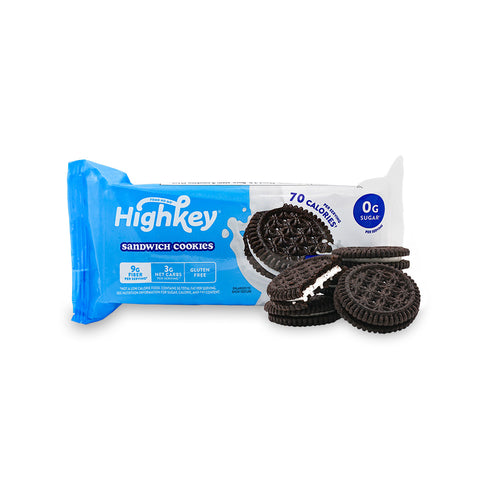 Blue and white High Key Sugar Free Sandwich Cookie package on a white background with four chocolate vanilla keto cookies outside of the package showing crisp cookie texture with creamy vanilla frosting in the center. . 