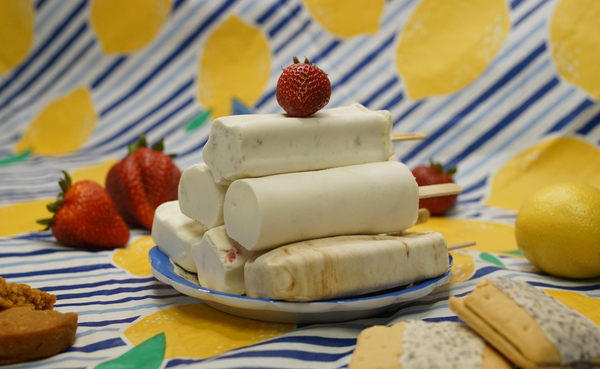 Stack of popsicles with strawberry on top