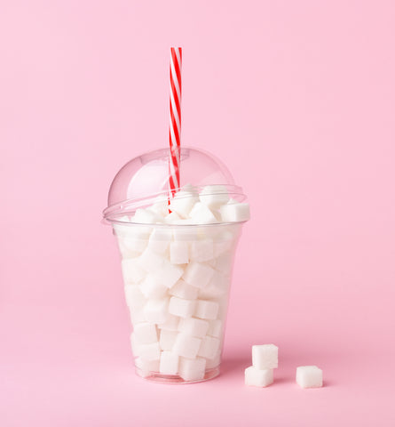 clear smoothie cup fill with sugar cubes