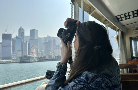 Wander with Nicole taking a photo on the Star Ferry 