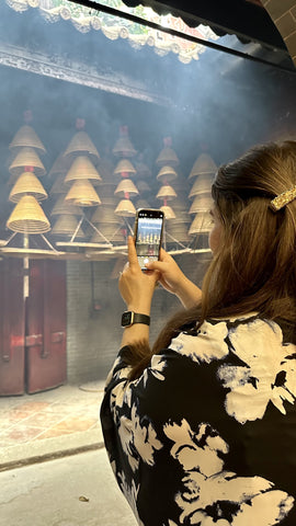 Girl taking a photo in a Hong Kong temple