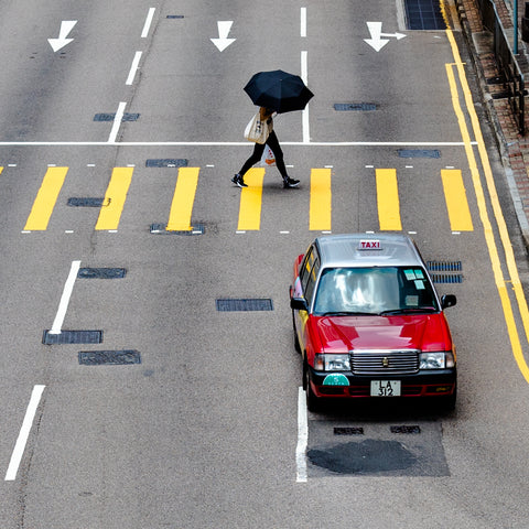 Hong Kong taxi with man with umbrella 