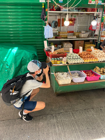 Teen taking pictures in the market in Hong Kong