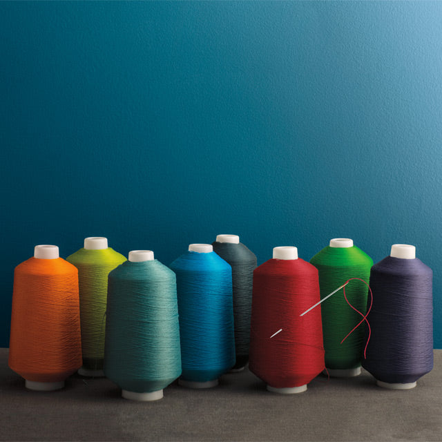 Multicolored sewing spools reflect the accentuated response to light found in Aura Color Stories.