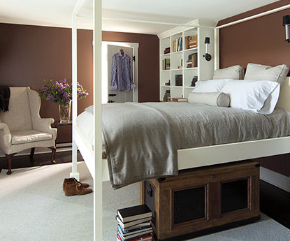 A bedroom painted in brown with white trim.