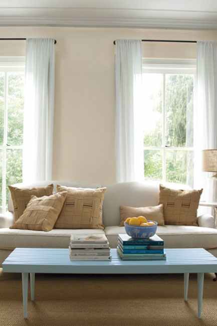 Neutral living room with twin floor-to-ceiling windows