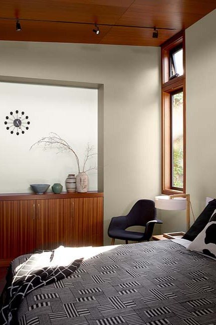 A modern wood based bedroom with neutral walls