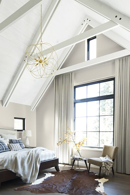Top floor bedroom with high white ceilings and neutral color palettes