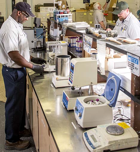 Benjamin Moore employees working on the quality control lab bench.