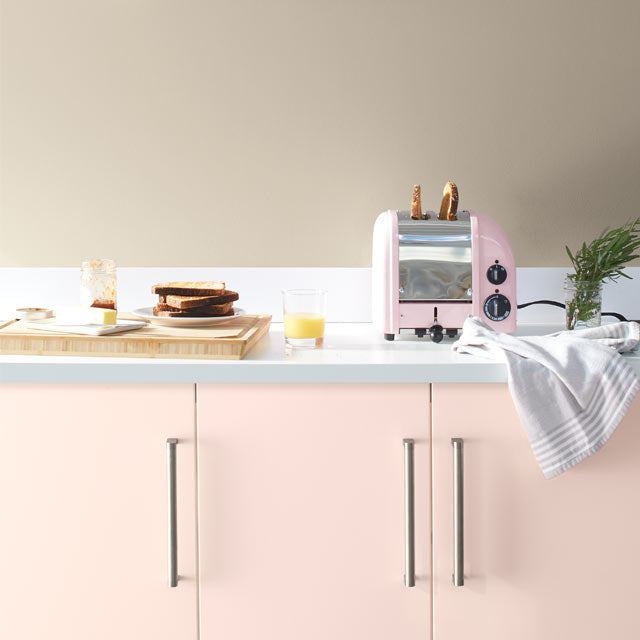 A pale kitchen with pink cabinets painted with Benjamin Moore's 2020 Color of the Year, First Light 2102-70