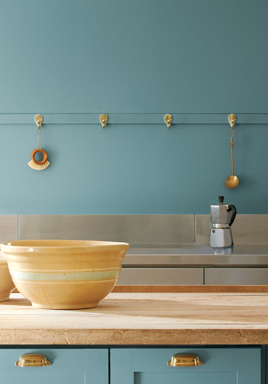 A kitchen with walls and cabinets painted with the Color of the Year 2021, Aegean Teal 2136-40.