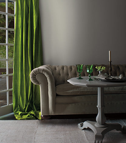 Bright green curtain against neutral gray wall.