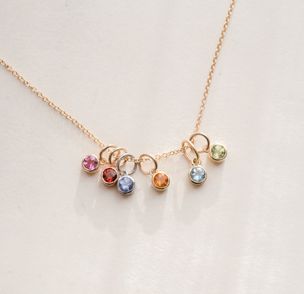 birthstone charms stacked on a necklace