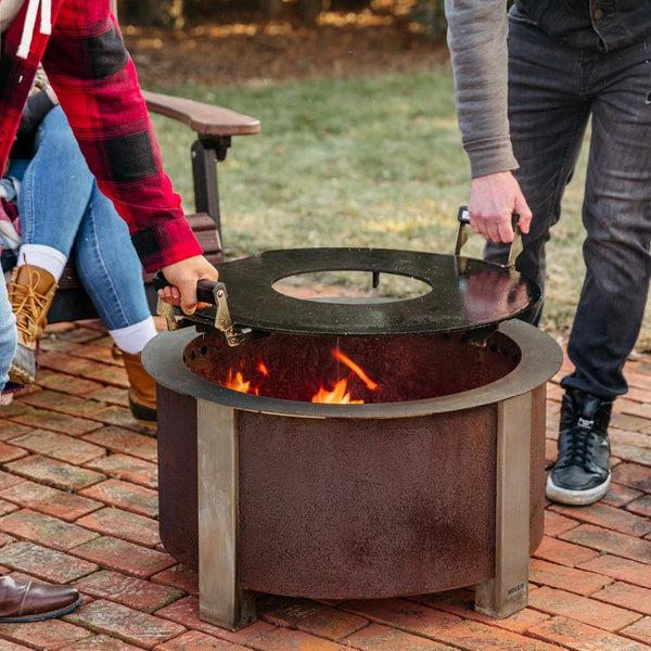 Removing the griddle from the fire pit