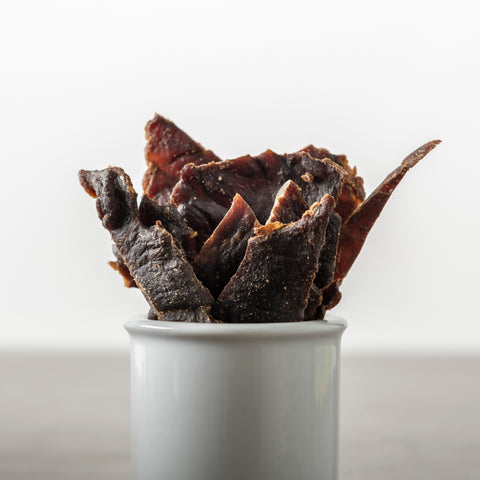 Crispy slices of beef jerky in a tin
